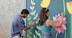 Wall art, friends and painting mural with smile for creativity, community project and student hobby. Woman, man and people for artist with diy decor, painter and flowers with expression outdoors
