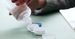 Optometry, contact lens and hands of person with liquid for eye care, health and wellness. Healthcare, medical and woman with solution in container for protection for vision, eyesight or prescription