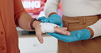Paramedic, hands or bandage with first aid training for injury, mobility or emergency service at office. Closeup, medical or strap with cotton or patient accident for bruise, wound or healthcare