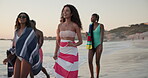 Beach, group and people with walking on vacation, holiday weekend and laughing by sunset in summer. Happy friends, men and women with conversation for travel, adventure and bonding together in ocean