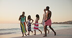 Beach, group and friends with walking on vacation, holiday weekend and having fun by sunset in summer. Happy people, men and women with conversation for travel, adventure or bonding together in ocean