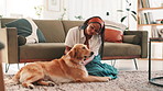 Relax, floor and woman with dog in home for bonding, relaxing and playing together in living room. Pet owner, best friend and African person with Golden Retriever for affection, petting and love