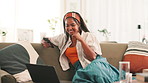 Laptop, phone and relax with black woman on sofa in living room of home for streaming service. Computer, social media and subscription entertainment with happy person in apartment for weekend