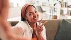Happy woman, face and selfie with peace sign for picture, photography or memory on sofa at home. Portrait, female person or user with smile, emoji or gesture for capture moment on couch at house