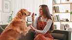 Treat, sofa and woman with dog for training, learning tricks and playing together in living room. Pet owner, happy and person with Golden Retriever with snacks for bonding, relax and love in home