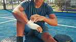 Paddle tennis, injury and bandage on hand for first aid, healing and health on court outdoor. Pain, hurt and man wrap wound for wellness, accident recovery and medical emergency after sports training