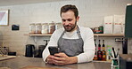 Smile, man and waiter with phone at cafe for online order, customer reviews and inventory management. Person, mobile and laughing with social media, supply chain and menu update for ecommerce website