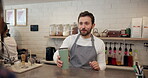 Barista, customer and takeaway coffee at counter for breakfast order, morning or espresso. Person, travel mug and sustainable cafe with beverage shop for small business service at bakery with man