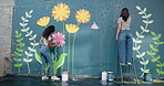 Back, women and friends for painting of wall for creative mural, community project and artistic freedom. People, artist and brush for public art, flower design and local culture for therapeutic hobby