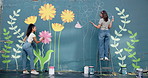 Smile, women and friends for painting of wall of creative mural, community project and artistic freedom. People, artist and brush for public art, flower design and local culture for therapeutic hobby