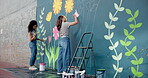 People, students and brush for painting on wall of creative mural, community project and artistic freedom. People, artist and diy for public art, flower design and local culture for therapeutic hobby