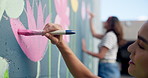 Wall art, woman and painting mural with brush for creativity, community project and student hobby. Girl, friends and people for artist with diy decor, painter and flowers with expression outdoors