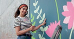 Face, woman and smile for painting wall for creative mural, community project and artistic freedom. Portrait, person and brush for public art, flower design and local culture with therapeutic process