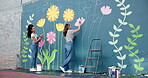 Wall art, women and painting mural with discussion for ladder, community project and student hobby. Girl, friends and people for artist with diy decor, painter and flowers with expression outdoors