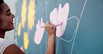 Artist, hand and painting on mural wall for creative flower, decoration design or student in city. Street art, happy woman and painter outdoor with brush for floral color, diy and hobby for culture