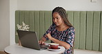 African woman, laptop and remote work at coffee shop for typing, review or schedule for project management. Person, virtual assistant and computer for admin, contact or feedback with proposal at cafe