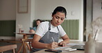 Small business, writing and woman with documents, cafe and calculation of costs for revenue and laptop. Startup, entrepreneur and inventory with tech in coffee shop, paperwork and planning for budget
