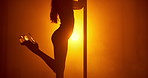 Woman, club and pole dancer in shadow for dance, exotic performance and seduction in spotlight. Orange neon, aesthetic and performer in silhouette for burlesque, stage light or space in private venue