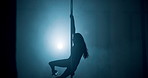 Exotic, dancing and woman in nightclub, pole and dancer with balance for show, talent and performance. Silhouette, artist and person with elegance for event, active or performer with outfit for party