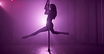Woman, dancing and pole with spin, stage and creativity with balance for concert event in dark. Person, exotic dancer and silhouette with swivel, performance and flexible for fantasy at nightclub
