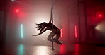 Dancer, dancing and pole in studio with neon lights, spinning or practice routine. Burlesque, people or exotic woman group on stage for choreography, nightlife or smoke for aesthetic in spotlight