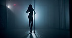 Woman, silhouette and pole dancer on stage for exotic performance, spin and flexibility in spotlight. Night club, performer and private routine with high heels, sensual movement and burlesque dancing
