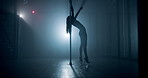 Woman, silhouette and flexible with pole on stage for exotic dancing, private performance and bend in spotlight. Nightclub, performer and burlesque routine with high heels, shadow or sensual movement