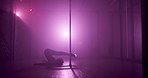 Neon light, pole dancing and woman on floor in nightclub, sexy or exotic choreography. Erotic dancer, performance and girl moving with flexibility, burlesque and sensual art for show or entertainment