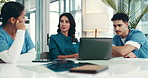 Doctors, meeting and laptop in boardroom at clinic, review and discussion with planning, report and feedback. People, surgeon and nurse in team for diagnosis, insight and medical research at hospital
