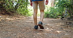 Legs, hiking and person with nature, walking and countryside with recreation, hobby and relax. Closeup, outdoor and hiker with path, wellness and health with journey, trekking or explore with fitness