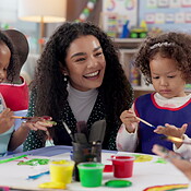 Painting, teacher and children with smile, art and creativity in ...