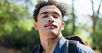 Hiking, backpack and man with breathing in nature for fresh air, travel adventure and sightseeing forest. Trekking, person and peaceful in woods for fitness break, thinking and reflection on journey
