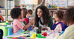 Art, woman and teacher with children, learning and creativity in classroom, growth or development. Painting, education and teaching kids in preschool, smile or talking to youth with color for artwork