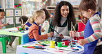 Painting, teacher and children with woman, care and creativity in classroom, growth and development. Education, teaching and kids with color for artwork, students and learning with smile in preschool