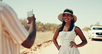 Phone, photograph and road trip with couple in desert together for honeymoon, travel or vacation. App, profile picture and social media with people outdoor in nature for bonding, journey or holiday