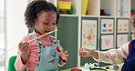 Kid, student and painting hand in classroom with creative lesson, drawing picture and kindergarten learning. Child, brush and messy with fun activity, artwork project and motor growth for education