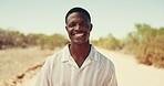 Desert, face and journey with black man outdoor for break, travel or vacation at sandy destination. Adventure, relax or road trip and happy tourist person in nature with smile for getaway or holiday