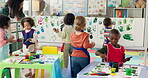 Painting, art and woman with children, teaching and education for group in daycare and learning. Talking, teacher and hands with color for growth, development and high five for kids in preschool