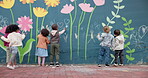 Art, mural and drawing with children and wall for friends, painting or community project. Flowers, learning and kindergarten education with group of kids in city for volunteer outreach program