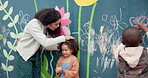 Board, writing and teacher with kids with chalk at school for creativity, art or learning. Education, students and educator with children for drawing on wall for development or growth at kindergarten