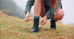 Hiking, mountain and woman tie shoes for travel on adventure, journey and walking in nature. Mockup space, fitness and legs of hiker with lace for exercise, workout and trekking outdoors for health