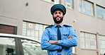 Arms crossed, crime and face of man police officer outdoor in city for patrol or security. Confident, safety and smile with happy cop person downtown in guard uniform for protection or trust