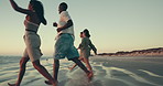 Running, friends and people on beach at sunset for holiday, summer vacation and adventure together. Nature, travel and men and women by sea, ocean and waves for freedom, happy and fun on weekend