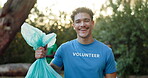 Volunteer, face or happy man with trash in nature, community service or social responsibility. Environment care, person or pride with dirt for recycling, clean up project or NGO about us in Portugal