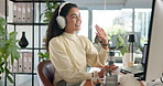Business woman, wave and video call with headphones for virtual meeting or online communication at office. Female person, employee or talking with smile on computer for remote discussion or chat
