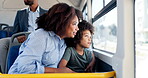 Happy, mother and child travel on bus with window, city commute and sightseeing adventure. Bonding, woman and curious son on public transport for family trip, discussion or journey on weekend break