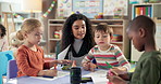 Woman, teacher and children with drawing in kindergarten classroom for early childhood development. Female person, educator or instructor talking to kids with fun activity or coloring at school