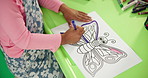 Person, hands and child with drawing above for coloring, fun activity or assessment at kindergarten school. Top view, kid or butterfly with pencil for fine motor skills or early childhood development