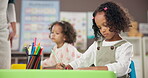 Child, school and girl drawing for art, learning and development in kindergarten classroom. Kids, writing and motor skills for growth, education progress and creative students with color at academy