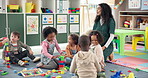 Teacher, kids and play with blocks in class for learning, problem solving and creative activity. Woman, students and building toys for education game, puzzle solution and motor growth in kindergarden